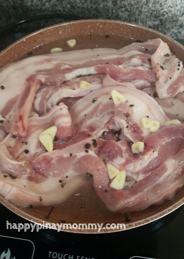 Boil the liempo slices in vinegar and water, plus seasoning for about 20-30 minutes.