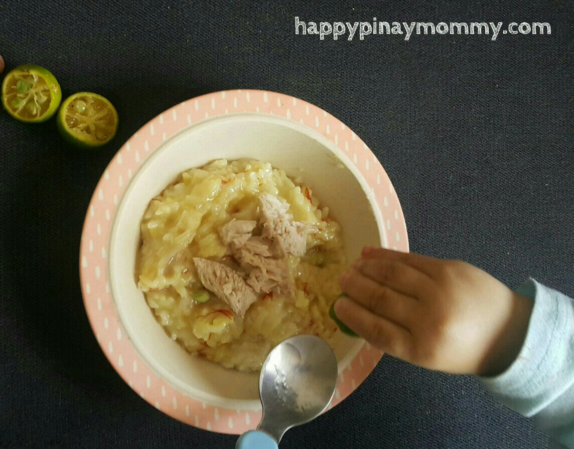 My BLW toddler Shoti is squeezing calamansi is his bowl of Arroz Caldo. It was a happy, rainy morning for him.