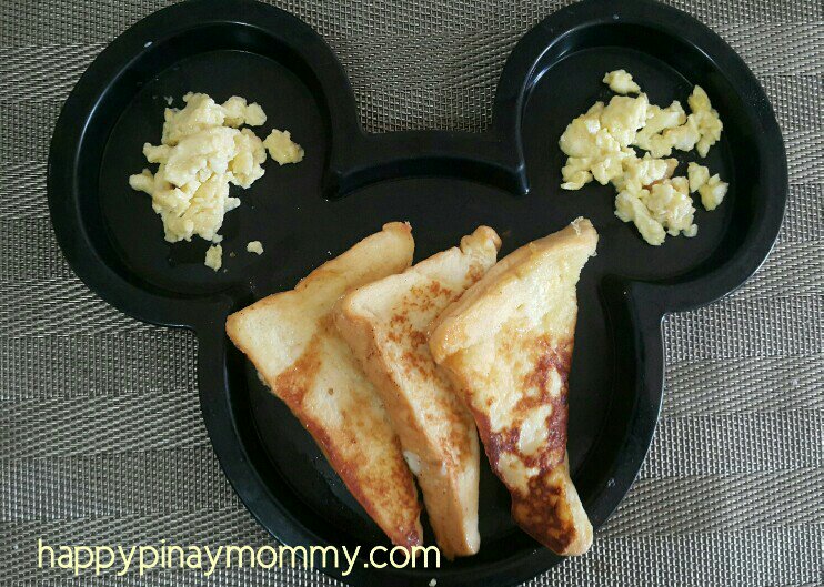 As a toddler (about 1.3 yo), he can already safely eat the toast sliced on a triangular fashion. He again eats it with his favorite scrambled eggs.